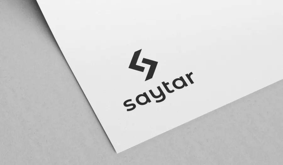 The Saytar logo on a sheet of white paper