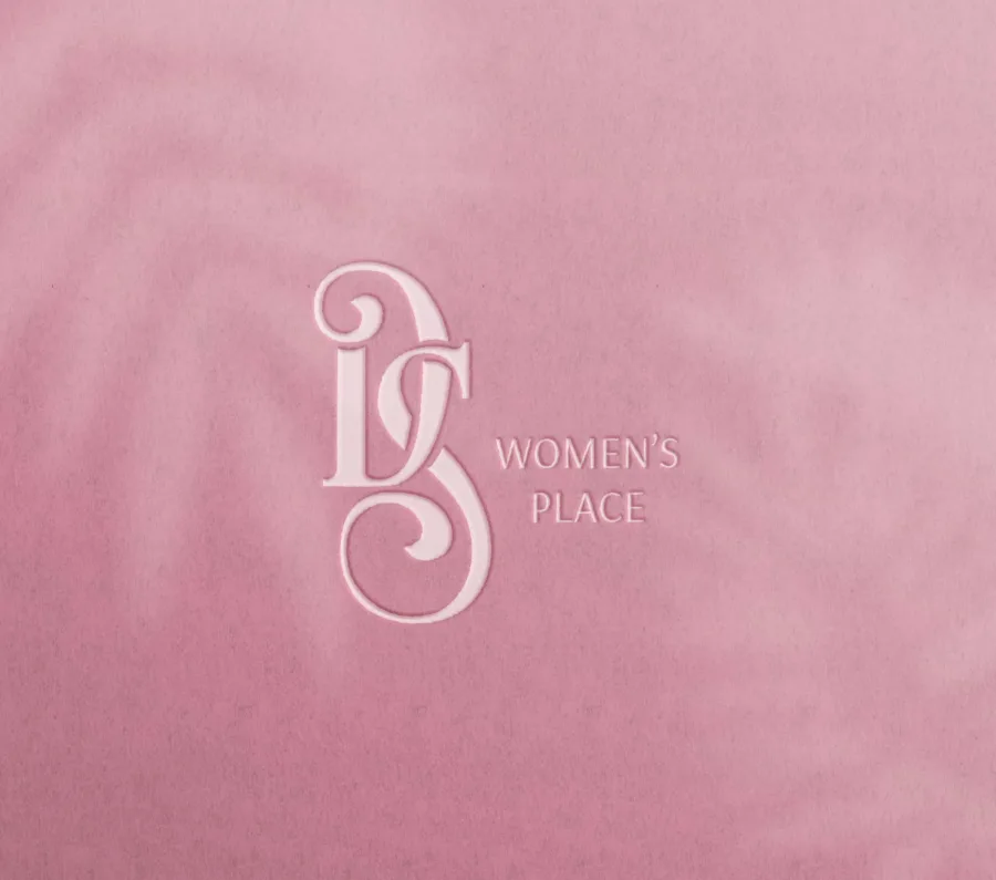 The DS Women's Place logo embossed on pink paper
