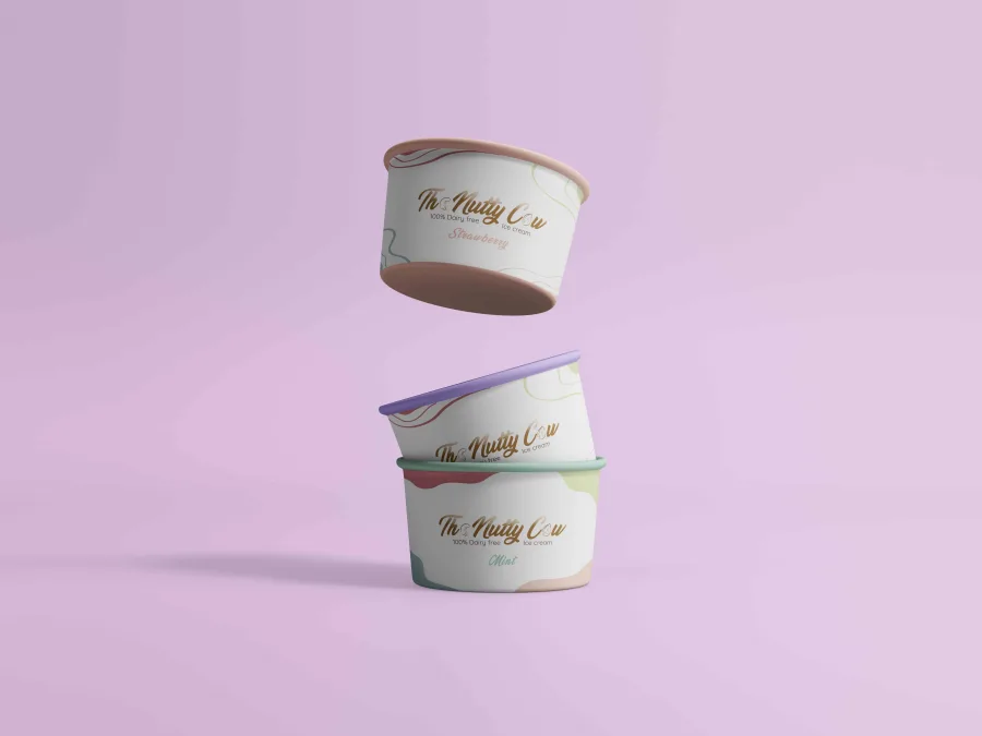 Three The Nutty Cow ice cream cups with coloured rims, for strawberry and mint