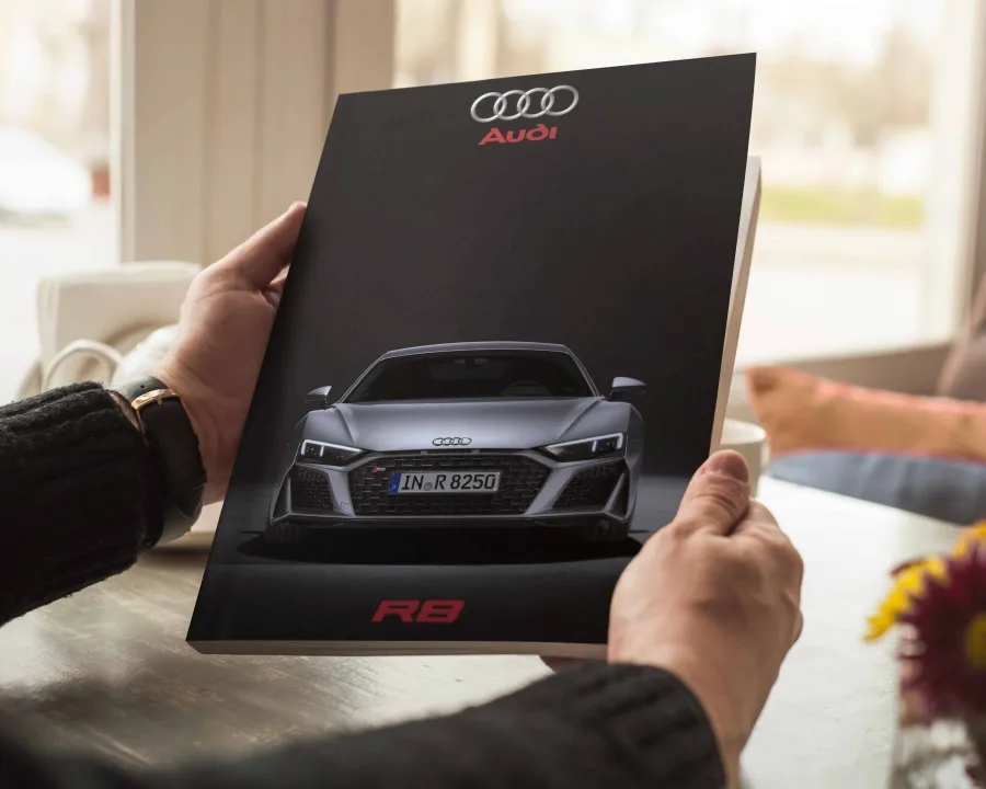 The catalogue cover: the Audi rings, the R8 head-on and a red R8 badge