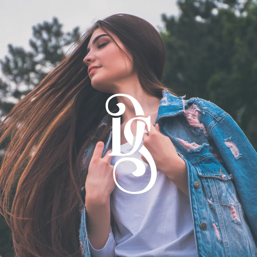 The white DS monogram over a fashion photograph of a young woman in a denim jacket