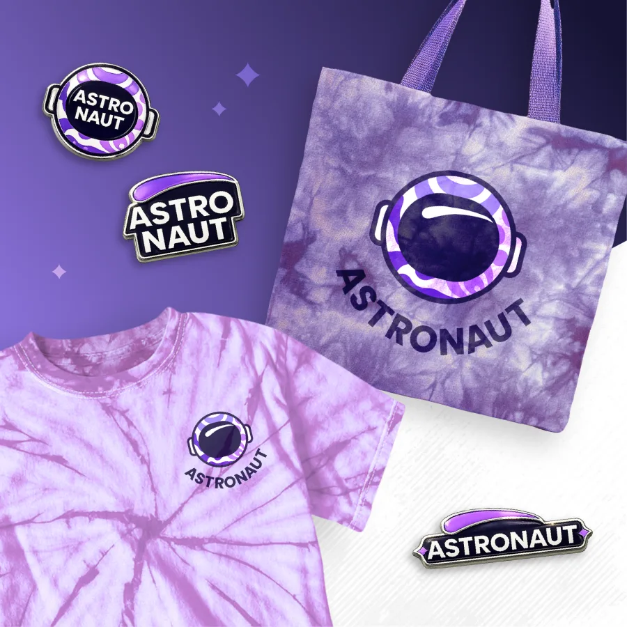 The Astronaut logo on pins, a tote bag and a T-shirt